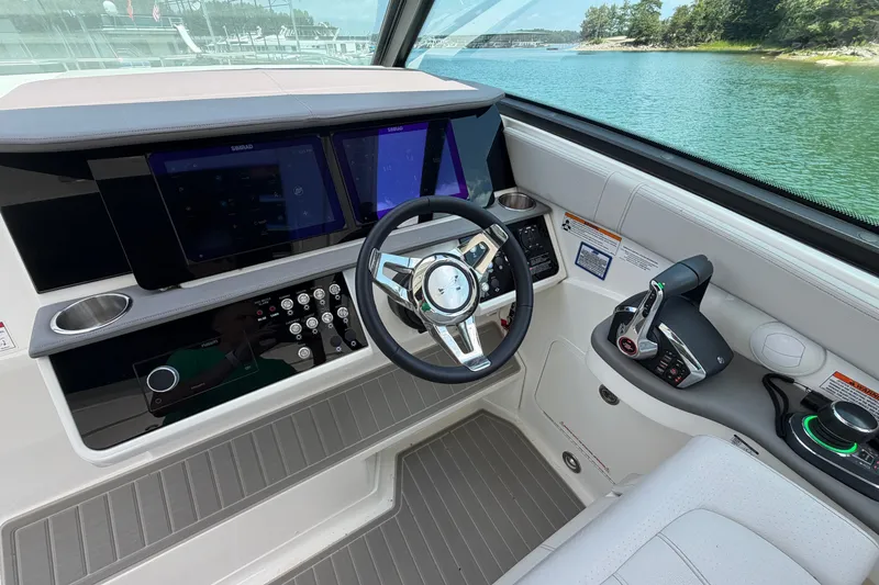 Slide: The Image of Helm of 2025 Sea Ray Sundancer 320 with modern controls and navigation displays. - 18