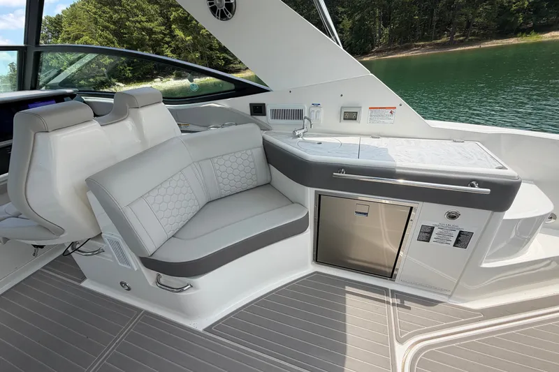 Slide: The Image of Interior of 2025 Sea Ray Sundancer 320 yacht with seating and kitchenette. - 21