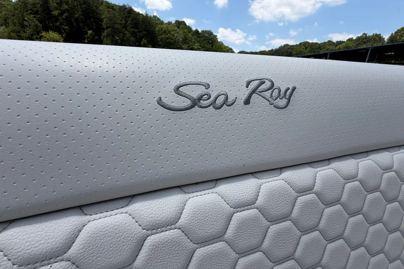 Slide: The Image of 2025 Sea Ray Sundancer 320 boat seat with embossed logo and textured upholstery. - 24