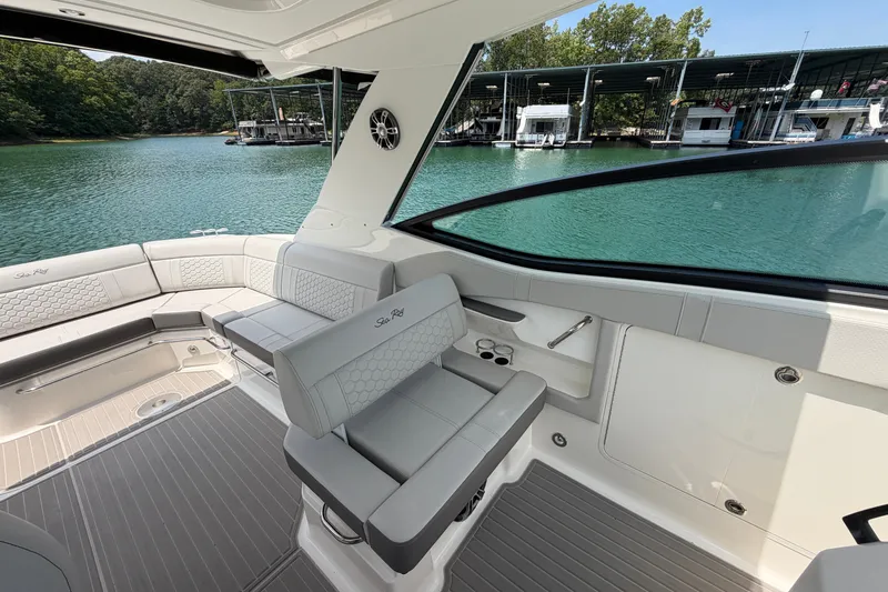 Slide: The Image of Interior of 2025 Sea Ray Sundancer 320 yacht with luxurious seating and scenic marina view. - 27