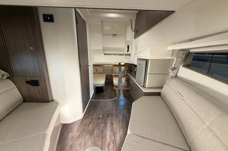 Slide: The Image of Interior of 2025 Sea Ray Sundancer 320 yacht, featuring modern seating and sleek design. - 34