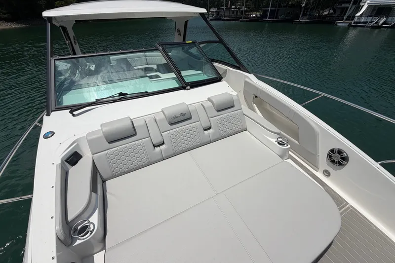 Slide: The Image of 2025 Sea Ray Sundancer 320 boat with spacious seating on calm water. - 30