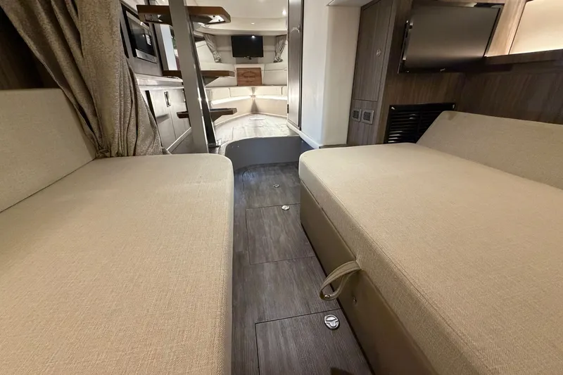 Slide: The Image of Interior of 2025 Sea Ray Sundancer 320, featuring cozy seating and modern amenities. - 35