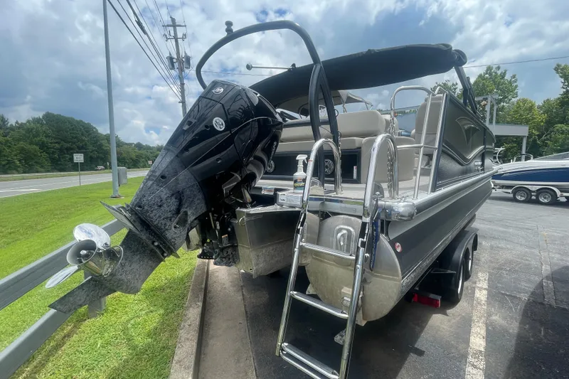 Slide: The Image of 2023 Premier SOLARIS 230 RL PTX pontoon boat with outboard motor and ladder. - 23