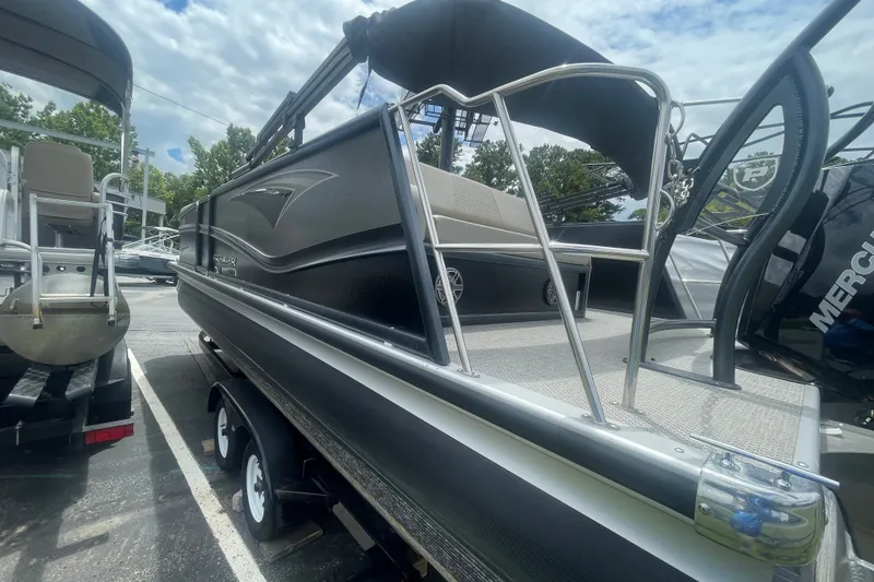 Slide: The Image of 2023 Premier SOLARIS 230 RL PTX pontoon boat with sleek black design and sturdy railing. - 24