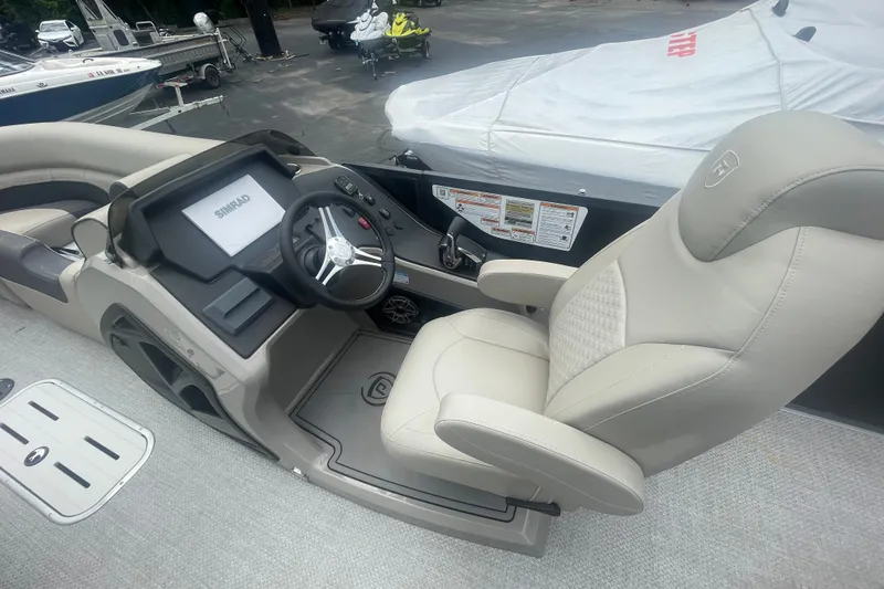 Slide: The Image of Captain's seat and helm of 2023 Premier SOLARIS 230 RL PTX boat, featuring Simrad display. - 10