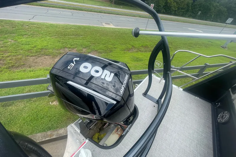 Slide: The Image of 2023 Premier SOLARIS 230 RL PTX boat with Mercury outboard motor, docked near a road. - 21