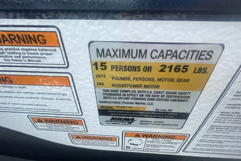 Slide: The Image of 2023 Premier SOLARIS 230 RL PTX boat capacity label, 15 persons or 2165 lbs maximum. - 17