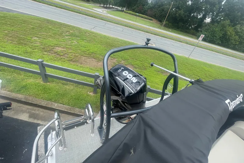 Slide: The Image of 2023 Premier SOLARIS 230 RL PTX boat with outboard motor, parked near a road. - 18