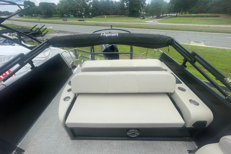 Slide: The Image of 2023 Premier SOLARIS 230 RL PTX boat interior with cushioned seating and cup holders. - 19