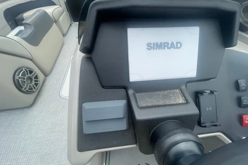 Slide: The Image of 2023 Premier SOLARIS 230 RL PTX dashboard featuring Simrad display and JL Audio system. - 11