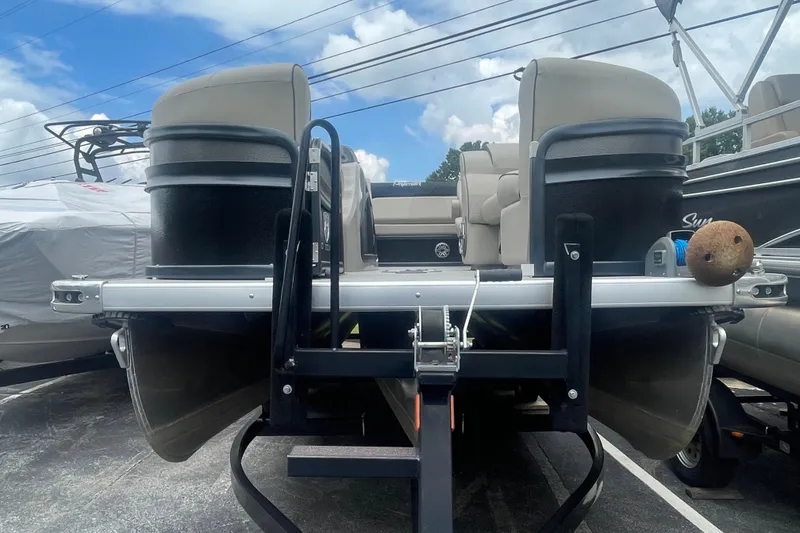 Slide: The Image of 2023 Premier SOLARIS 230 RL PTX pontoon boat on trailer, under blue sky. - 3