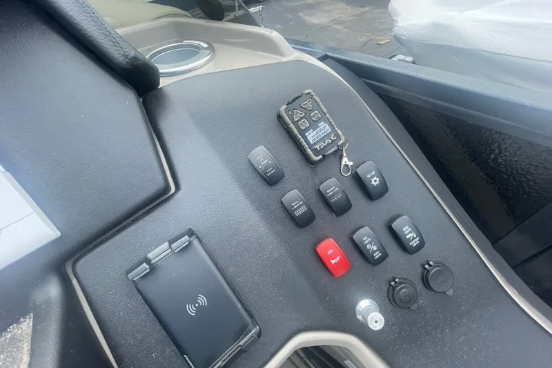 Slide: The Image of Control panel of 2023 Premier SOLARIS 230 RL PTX boat with switches and remote. - 12