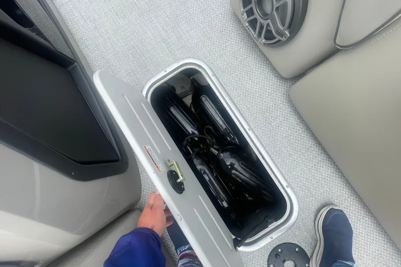 Slide: The Image of Storage compartment on 2023 Premier SOLARIS 230 RL PTX boat, open with items inside. - 7