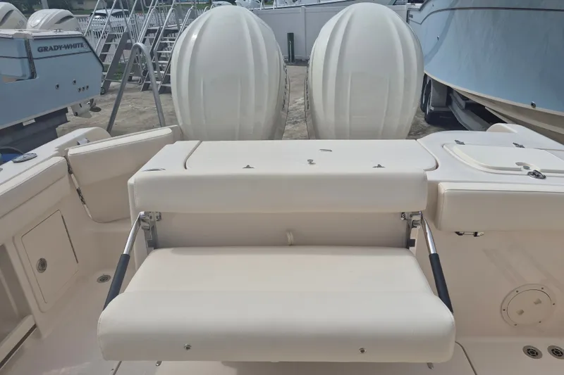Slide: The Image of 2027 Grady-White Freedom 285 boat interior with seating and dual engines. - 16