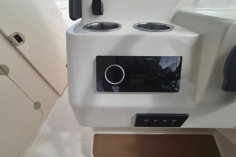 Slide: The Image of Control panel and cup holders on 2027 Grady-White Freedom 285 boat interior. - 11