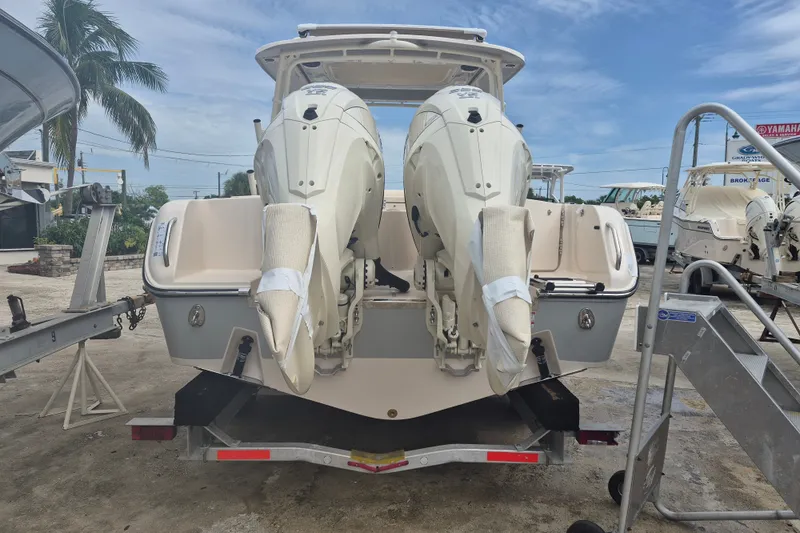 Slide: The Image of 2027 Grady-White Freedom 285 boat with dual engines on trailer, outdoor setting. - 22