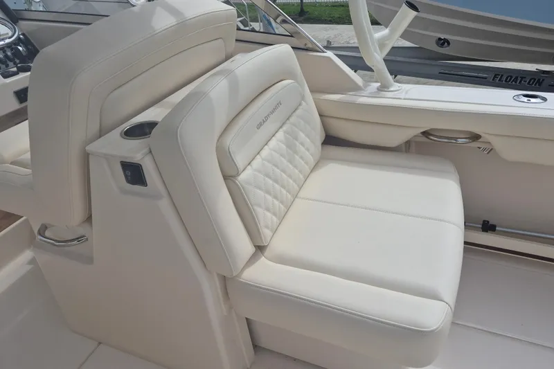 Slide: The Image of Luxurious seating on 2027 Grady-White Freedom 285 boat, featuring elegant white upholstery. - 15