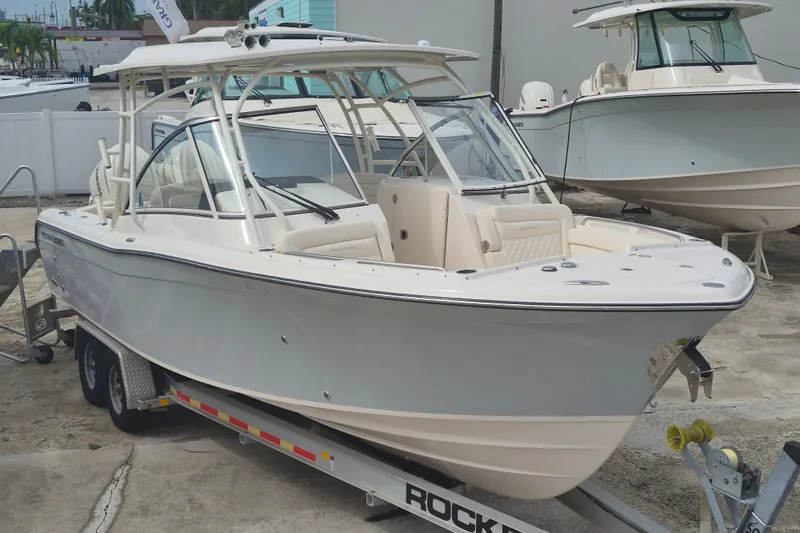 Slide: The Image of 2027 Grady-White Freedom 285 boat on trailer, parked outdoors. - 3