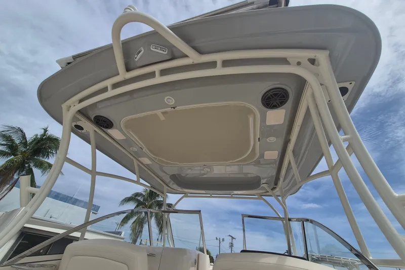 Slide: The Image of 2027 Grady-White Freedom 285 boat canopy with speakers, under a clear blue sky. - 18
