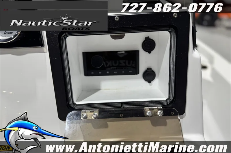 Slide: The Image of 2025 NauticStar 194 Bay boat dashboard with storage compartment and controls. - 21