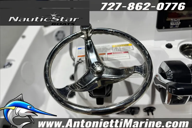 Slide: The Image of Steering wheel of 2025 NauticStar 194 Bay boat with contact details and logo. - 19