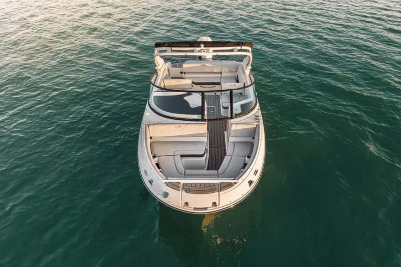 Slide: The Image of Aerial view of a Sea Ray SDX 230 Outboard on calm water, featuring sleek design and spacious deck. - 8