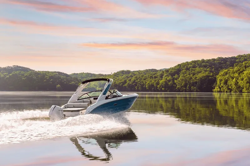 Slide: The Image of 2027 Sea Ray SDX 230 Outboard on a calm lake at sunset. - 5