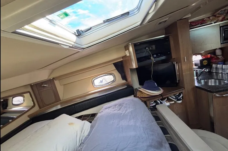 Slide: The Image of 2011 CHAPPARELL Signature 330 cabin interior with bed, skylight, and kitchenette. - 22