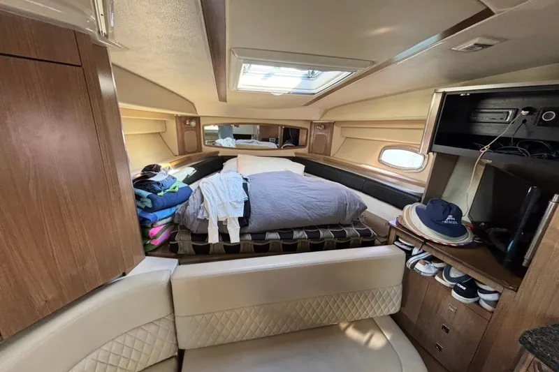 Slide: The Image of 2011 CHAPPARELL Signature 330 cabin interior with bed, storage, and seating area. - 23