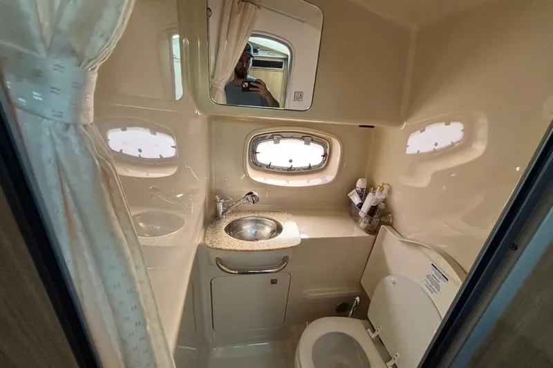 Slide: The Image of 2011 CHAPPARELL Signature 330 boat bathroom with sink, toilet, and window. - 27