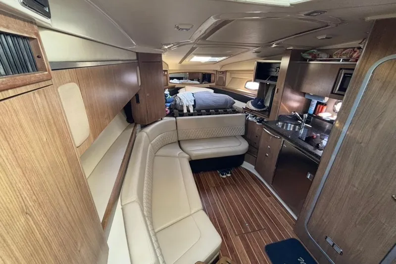 Slide: The Image of Interior of 2011 CHAPPARELL Signature 330 boat with wood finish and cozy seating area. - 16