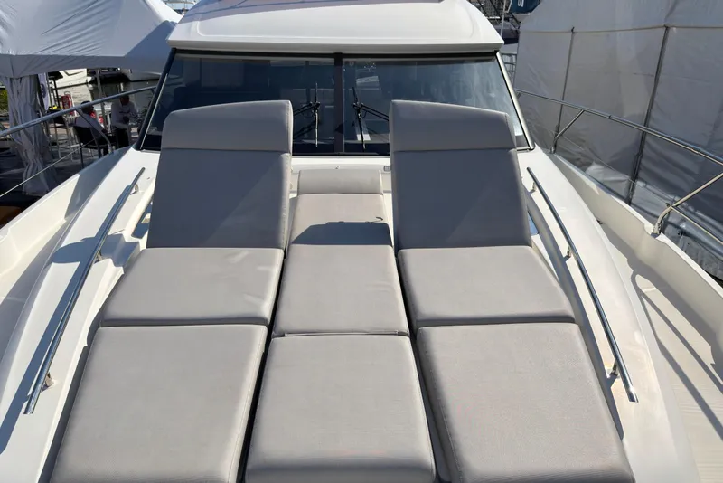 Slide: The Image of 2023 Prestige 520 yacht with luxurious sun loungers on deck. - 21
