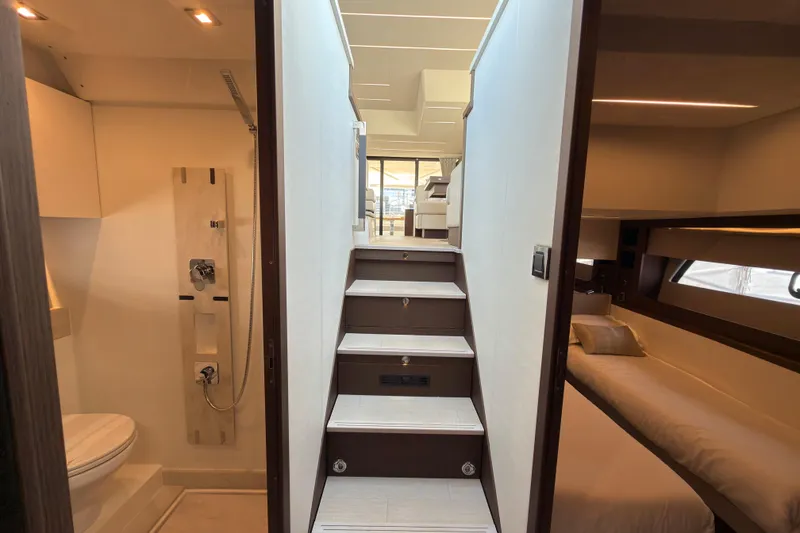 Slide: The Image of Interior of 2023 Prestige 520 yacht featuring stairs, bathroom, and bedroom. - 19
