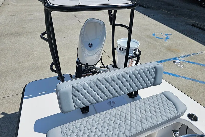Slide: The Image of 2025 Delta Boatworks Delta D18 with quilted seating and outboard motor, docked on concrete. - 20