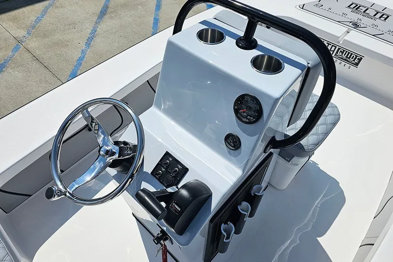 Slide: The Image of 2025 Delta Boatworks Delta D18 helm with steering wheel, gauges, and cup holders. - 19