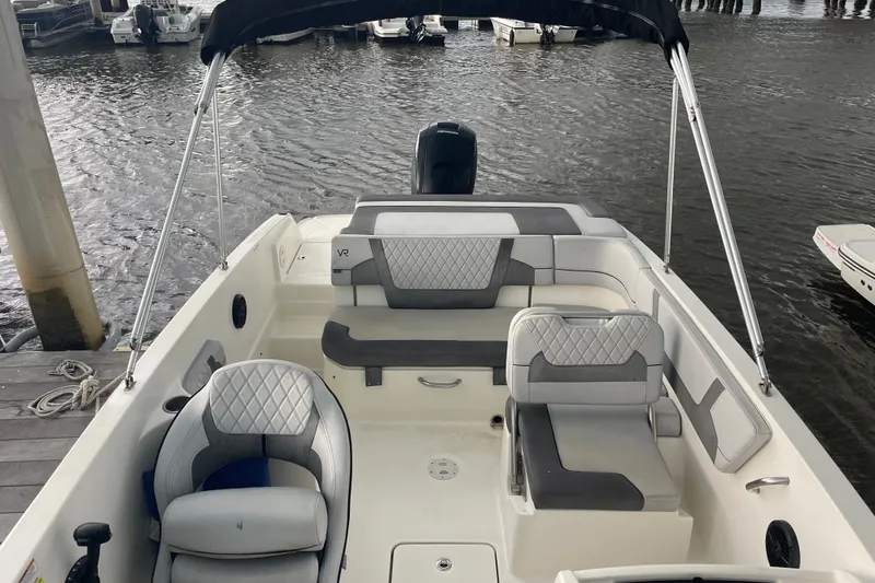 Slide: The Image of 2023 Bayliner VR6 Bowrider OB with spacious seating, docked by the water. - 7