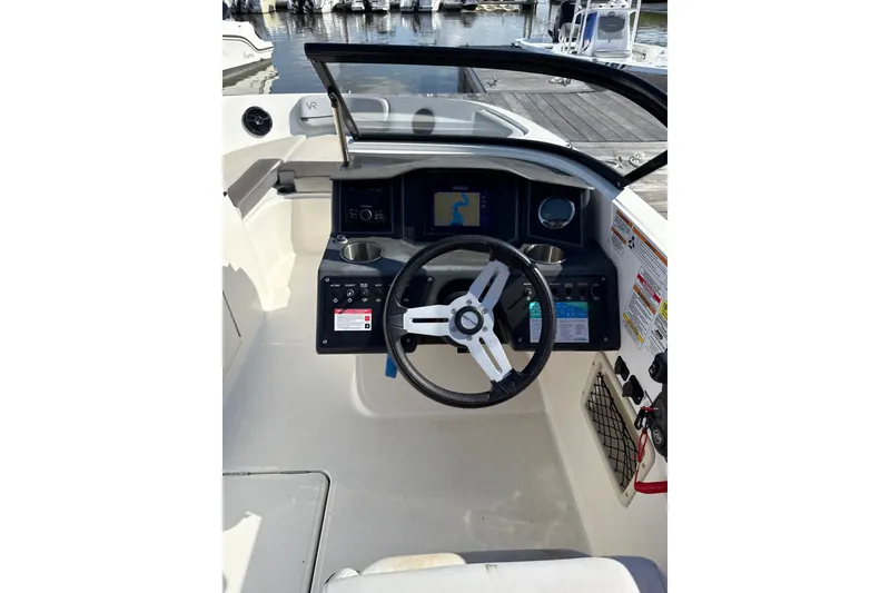 Slide: The Image of 2023 Bayliner VR6 Bowrider OB helm with steering wheel and navigation display. - 9
