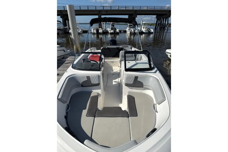 Slide: The Image of 2023 Bayliner VR6 Bowrider OB at dock, showcasing spacious seating and sleek design. - 5