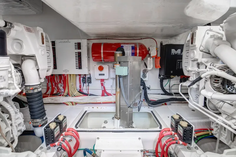 Slide: The Image of Engine room of 2021 Viking 46 Billfish, showcasing wiring and machinery components. - 21