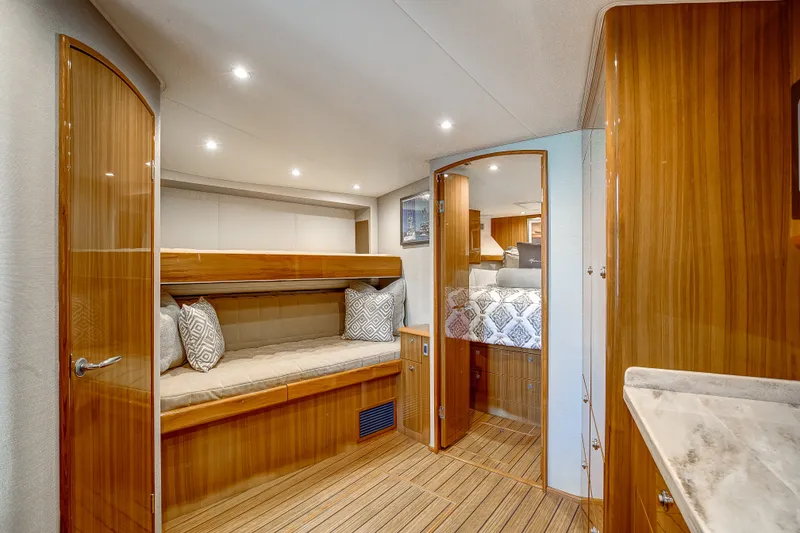 Slide: The Image of Luxurious interior of 2021 Viking 46 Billfish yacht with wood finishes and cozy sleeping area. - 17