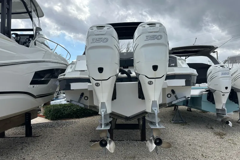 Slide: The Image of 2019 Cruisers Yachts 338 Outboard with twin 350 engines, docked under cloudy skies. - 36