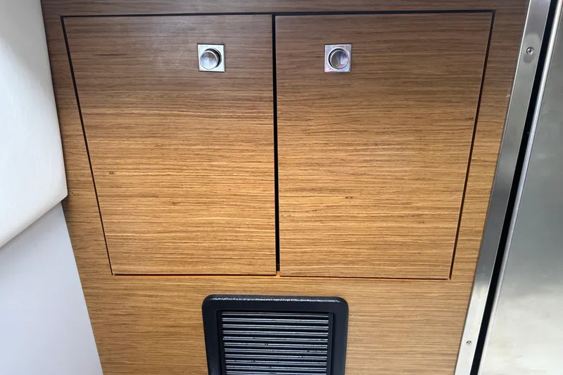 Slide: The Image of Wooden cabinet doors on a 2019 Cruisers Yachts 338 Outboard. - 16