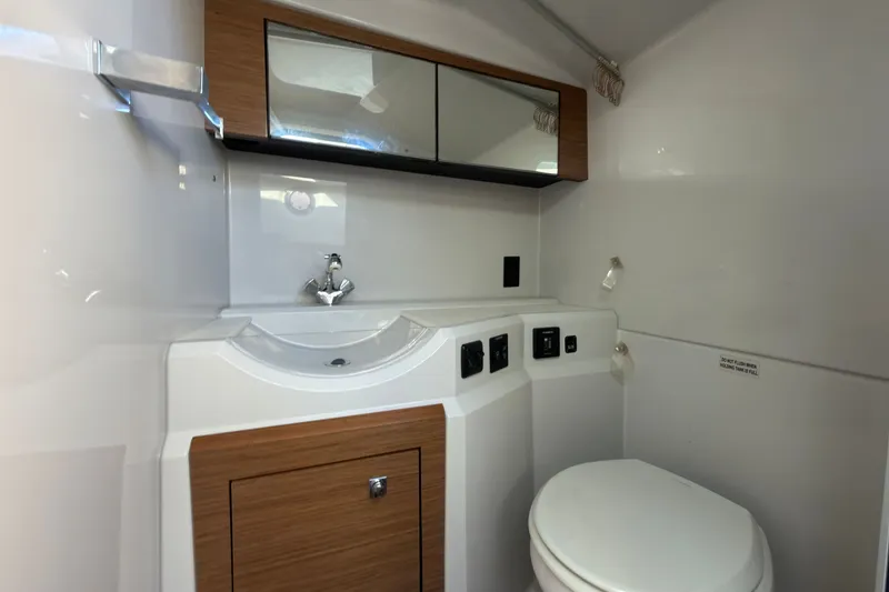 Slide: The Image of 2019 Cruisers Yachts 338 Outboard bathroom with modern sink and toilet design. - 13