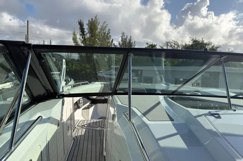 Slide: The Image of 2019 Cruisers Yachts 338 Outboard boat deck with sleek design and clear windshield. - 21