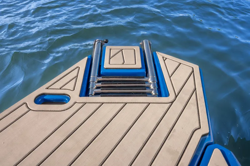 Slide: The Image of Sleek Hanover 347 boat deck with ladder, 2026 model, on calm blue water. - 16