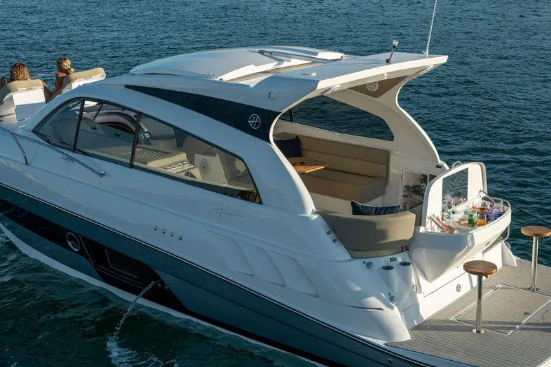 Slide: The Image of Luxury Hanover 375 yacht cruising on water, 2026 model, with elegant seating and bar area. - 55