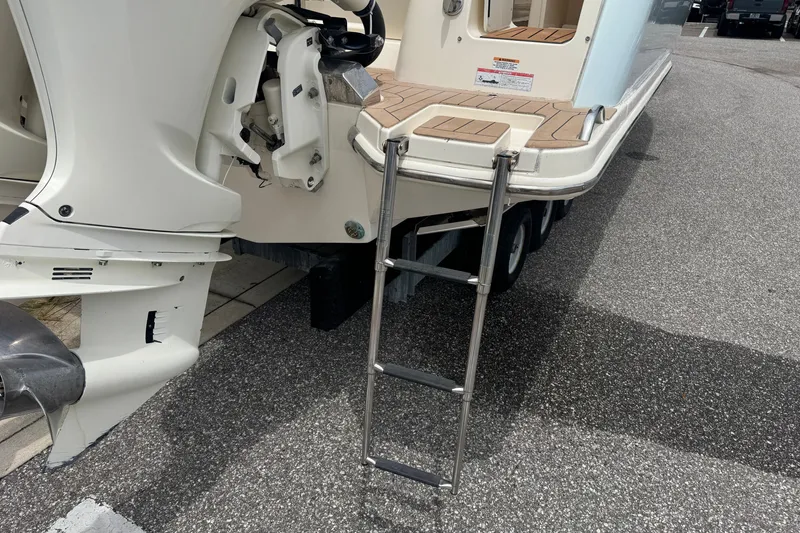 Slide: The Image of 2022 Scout 277 Dorado boat with ladder and outboard motor on display. - 35