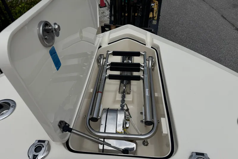 Slide: The Image of 2022 Scout 277 Dorado boat anchor compartment with stainless steel fittings and ladder. - 12