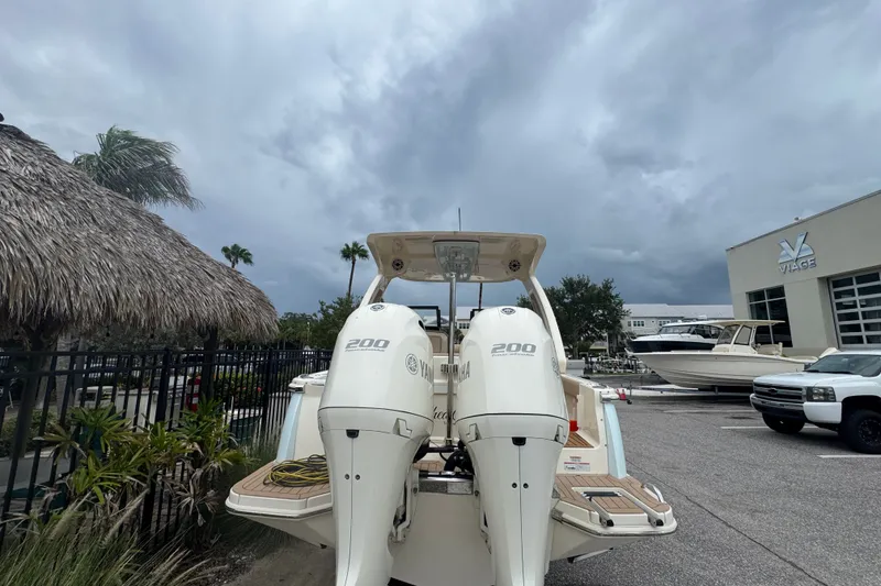 Slide: The Image of 2022 Scout 277 Dorado boat with dual Yamaha engines in a marina setting. - 9